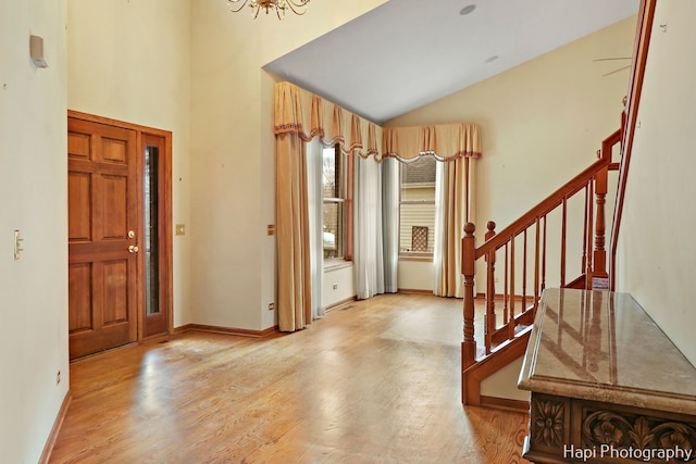 foyer entrance featuring light hardwood / wood-style flooring and vaulted ceiling