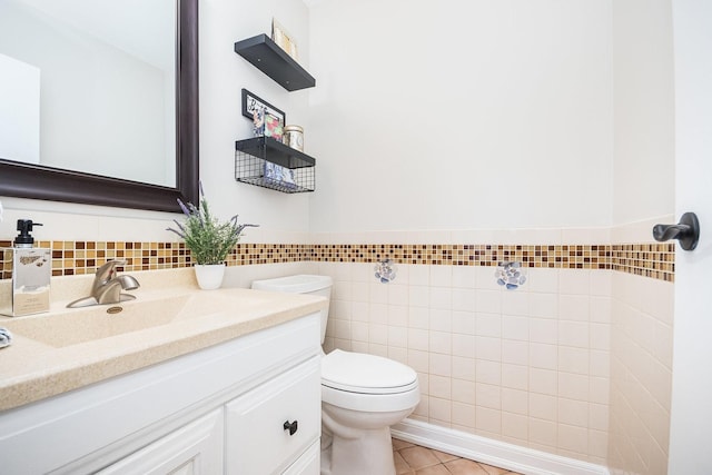 bathroom featuring vanity, tile patterned floors, tile walls, and toilet