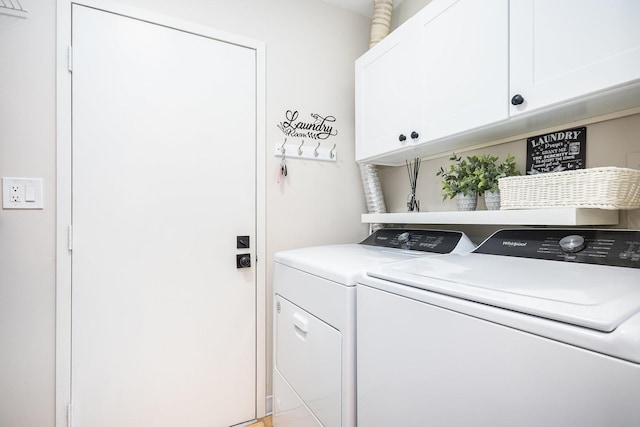 laundry room featuring separate washer and dryer and cabinets