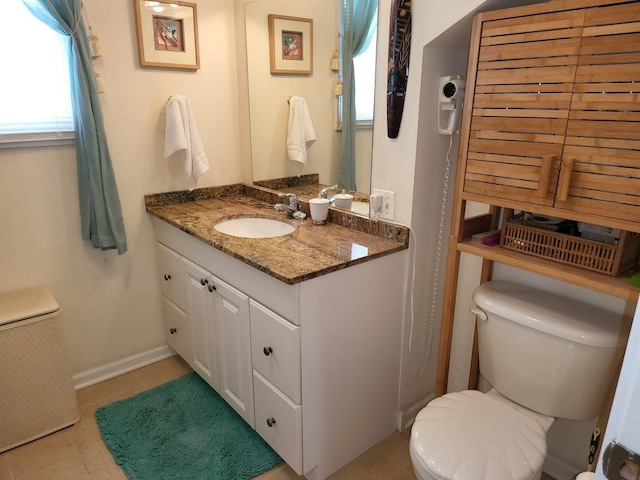 bathroom with vanity, tile patterned floors, and toilet