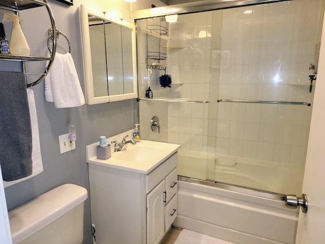 full bathroom with vanity, toilet, and combined bath / shower with glass door