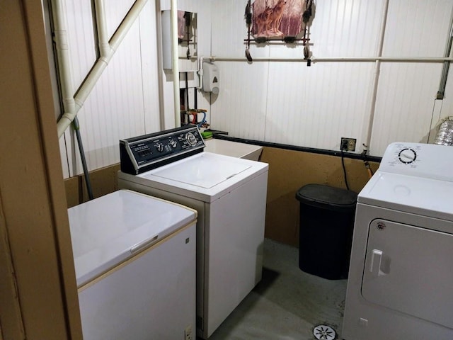 clothes washing area with washing machine and dryer