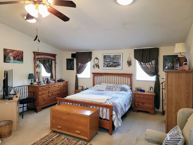 carpeted bedroom featuring lofted ceiling and multiple windows