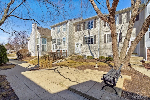 back of house featuring cooling unit and a residential view