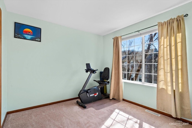 exercise room featuring carpet flooring, baseboards, and visible vents