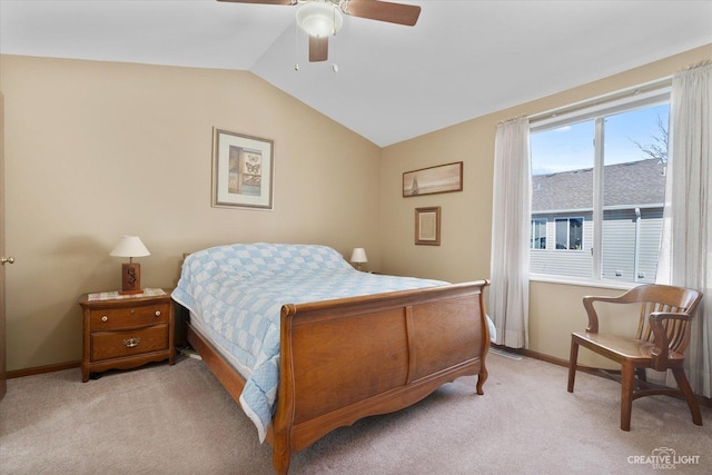 carpeted bedroom with vaulted ceiling, a ceiling fan, and baseboards