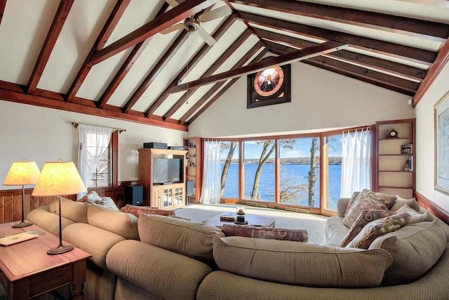 living room with beamed ceiling, ceiling fan, and high vaulted ceiling