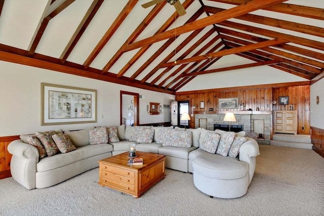 living room featuring ceiling fan, wooden walls, and high vaulted ceiling