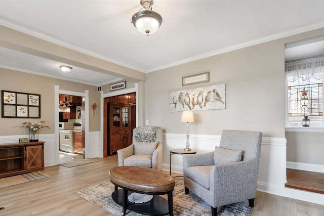 sitting room featuring wood-type flooring and crown molding