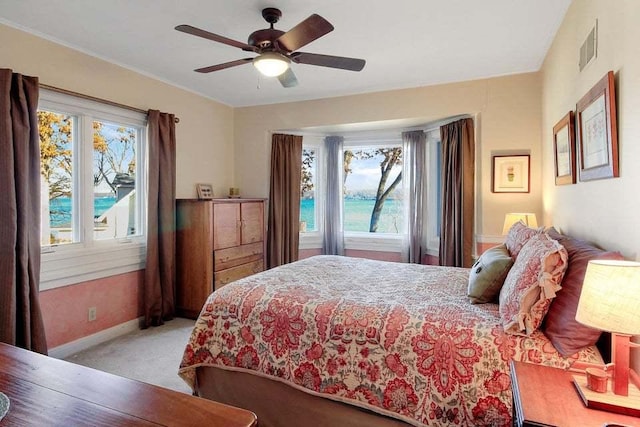 bedroom with light colored carpet and ceiling fan