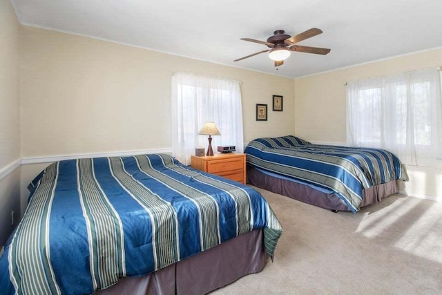 bedroom with ornamental molding, ceiling fan, and carpet flooring