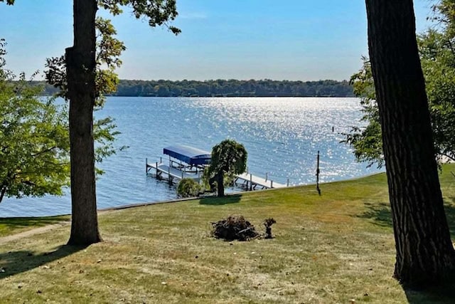 dock area featuring a lawn and a water view