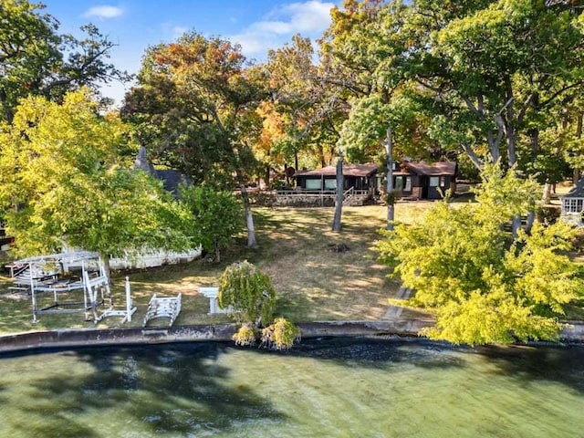 view of property's community featuring a water view and a dock