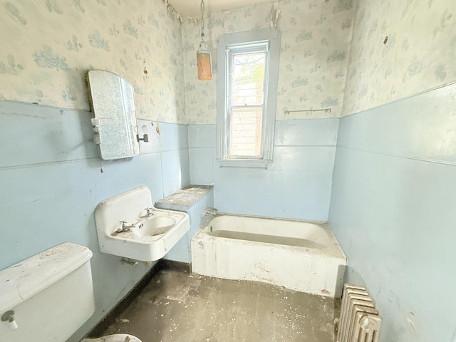 7243 S Perry Ave, Chicago, IL 60621 - full bath with wallpapered walls, wainscoting, toilet, a garden tub, and tile walls