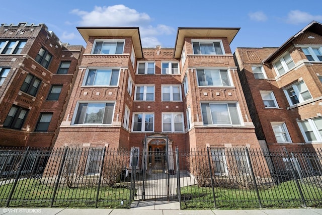 view of building exterior with a fenced front yard