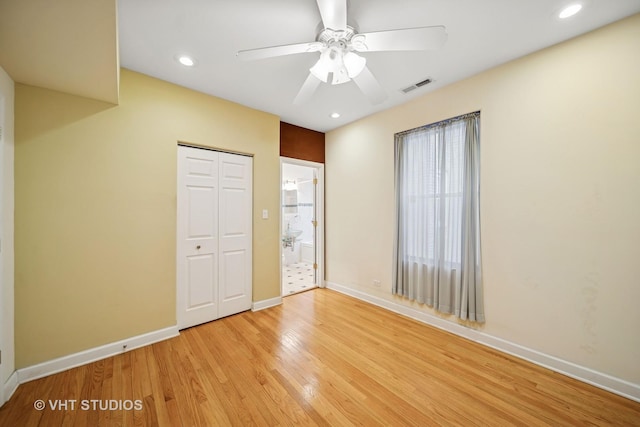 unfurnished bedroom featuring visible vents, baseboards, recessed lighting, light wood-style floors, and a closet