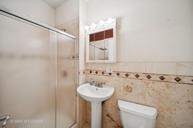 6742 S Clyde Ave Unit 1S, Chicago, IL 60649 - full bathroom with a stall shower, tile walls, and wainscoting