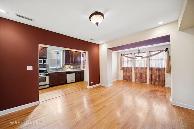 kitchen featuring visible vents, decorative backsplash, light wood-style floors, dishwasher, and stainless steel gas stove