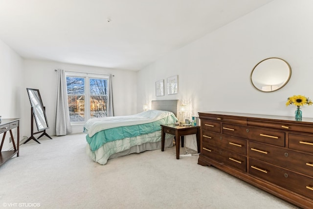 bedroom featuring light colored carpet