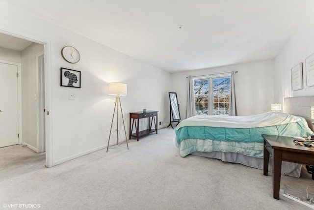 bedroom featuring light carpet and baseboards