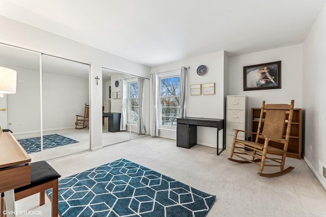 sitting room featuring carpet floors and baseboards