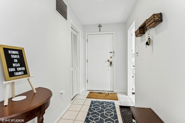 entryway featuring visible vents, baseboards, and light tile patterned floors