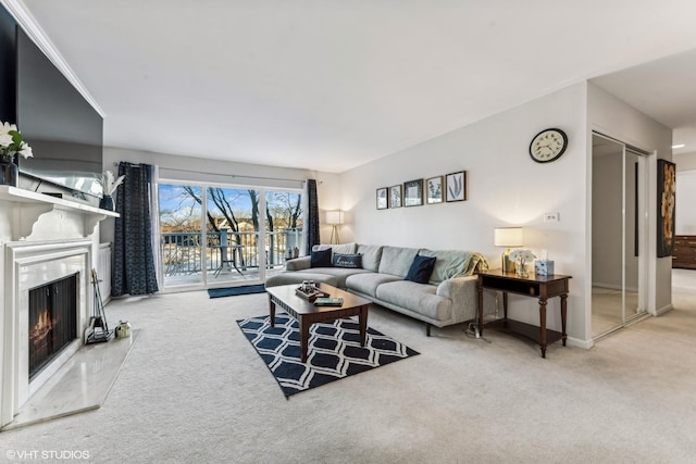 living area with a high end fireplace, carpet flooring, and baseboards