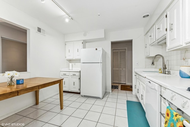 kitchen with white appliances, visible vents, white cabinets, light countertops, and a sink