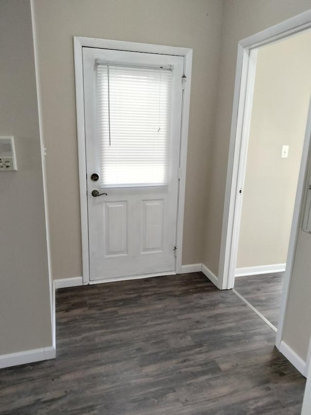 doorway with dark wood-type flooring