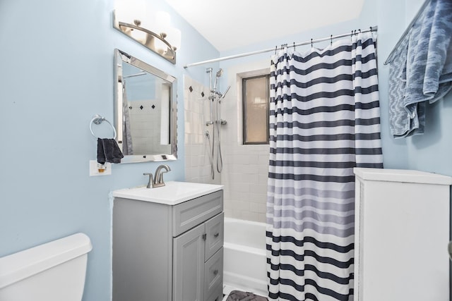 full bathroom featuring vanity, shower / tub combo, and toilet