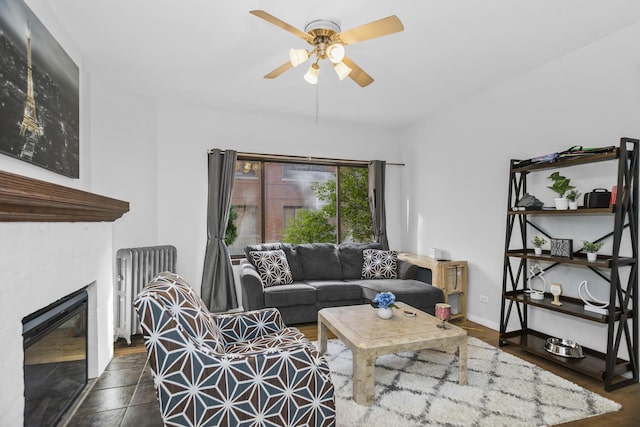 living room featuring ceiling fan, dark hardwood / wood-style flooring, and radiator