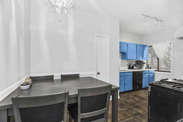 kitchen with dishwasher, dark tile patterned floors, blue cabinetry, track lighting, and gas range oven