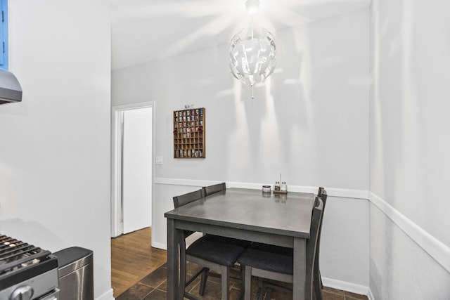 dining room featuring dark wood-type flooring and an inviting chandelier