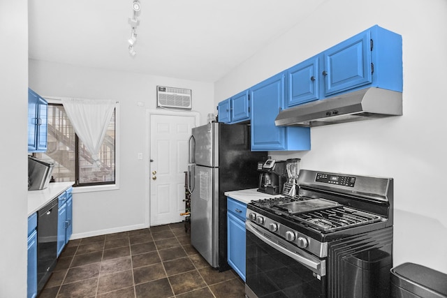 kitchen with an AC wall unit, dark tile patterned flooring, stainless steel appliances, blue cabinetry, and track lighting