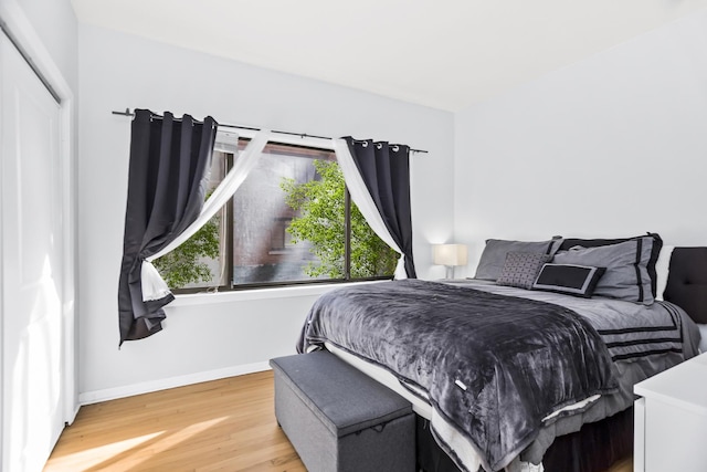 bedroom with hardwood / wood-style floors and a closet