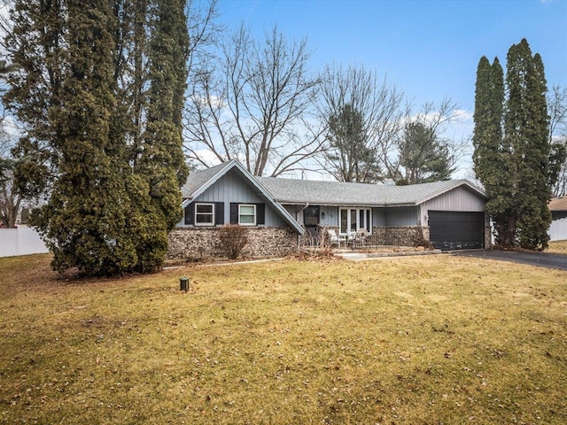 view of front of property featuring a garage and a front yard