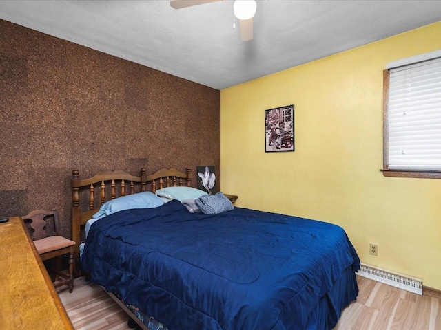 bedroom featuring light hardwood / wood-style flooring and ceiling fan