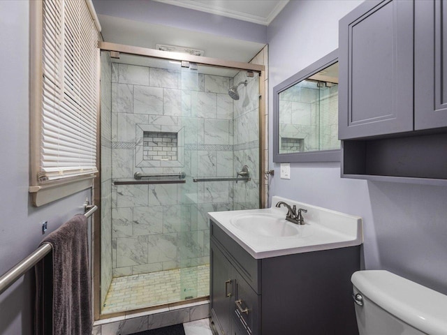 bathroom with a shower with door, vanity, ornamental molding, and toilet