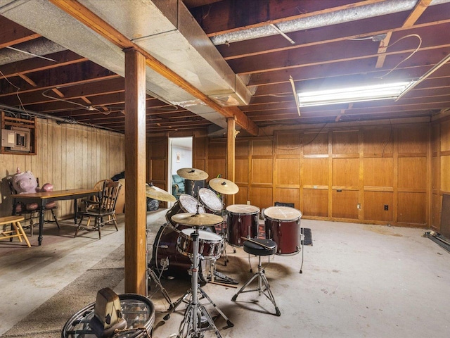 basement featuring wood walls