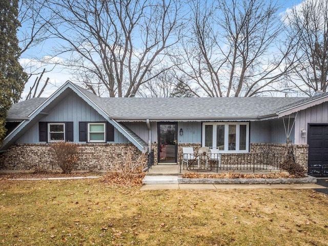 ranch-style house with a garage and a front yard