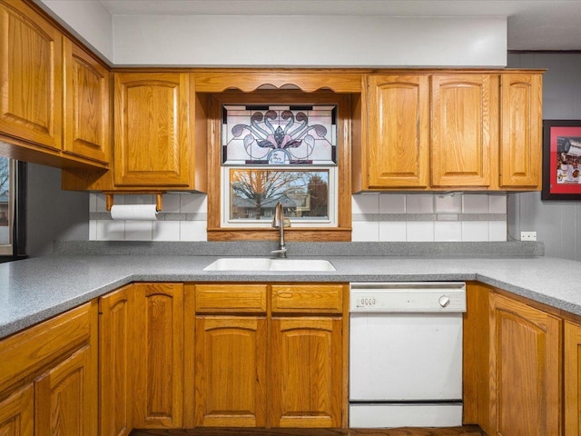 kitchen with tasteful backsplash, dishwasher, and sink