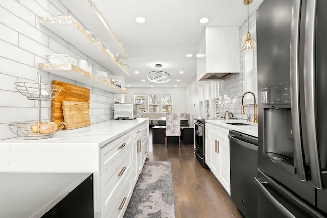 kitchen featuring sink, hanging light fixtures, appliances with stainless steel finishes, dark hardwood / wood-style flooring, and white cabinets