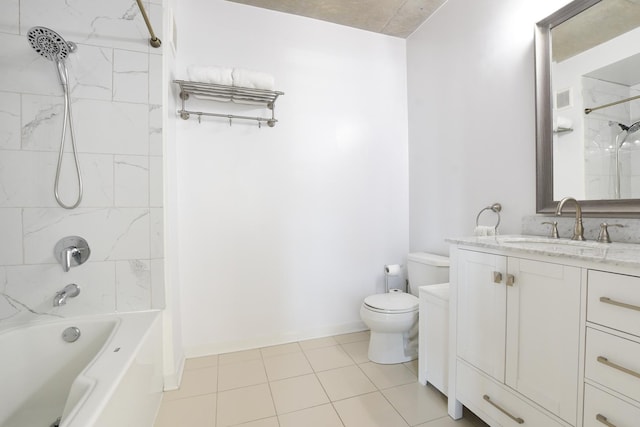 full bathroom featuring vanity, tile patterned floors, toilet, and tiled shower / bath