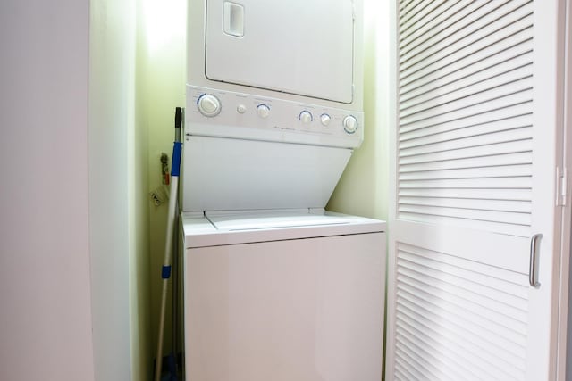 laundry area with stacked washing maching and dryer