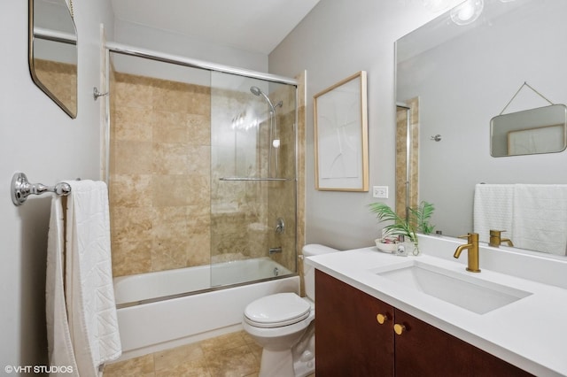 full bathroom with tile patterned flooring, vanity, shower / bath combination with glass door, and toilet