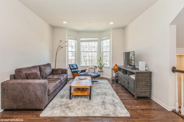 living room with recessed lighting, dark wood-type flooring, and baseboards