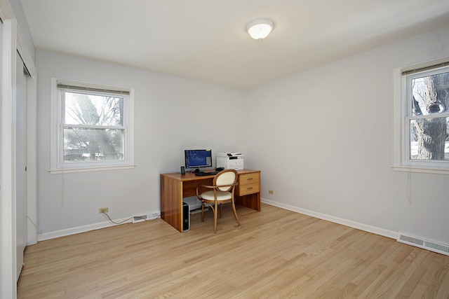 office with light hardwood / wood-style flooring