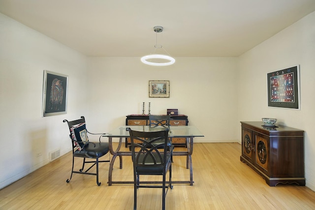 dining space featuring light wood-type flooring