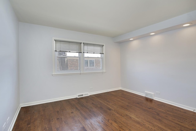 unfurnished room with dark wood-type flooring