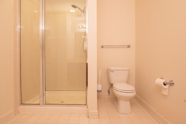 bathroom with walk in shower, tile patterned floors, and toilet